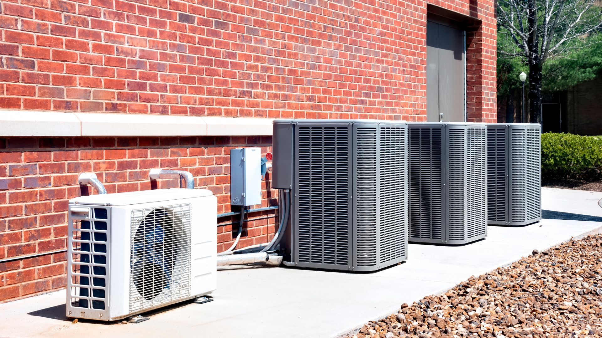 HVAC units outside a large brick building
