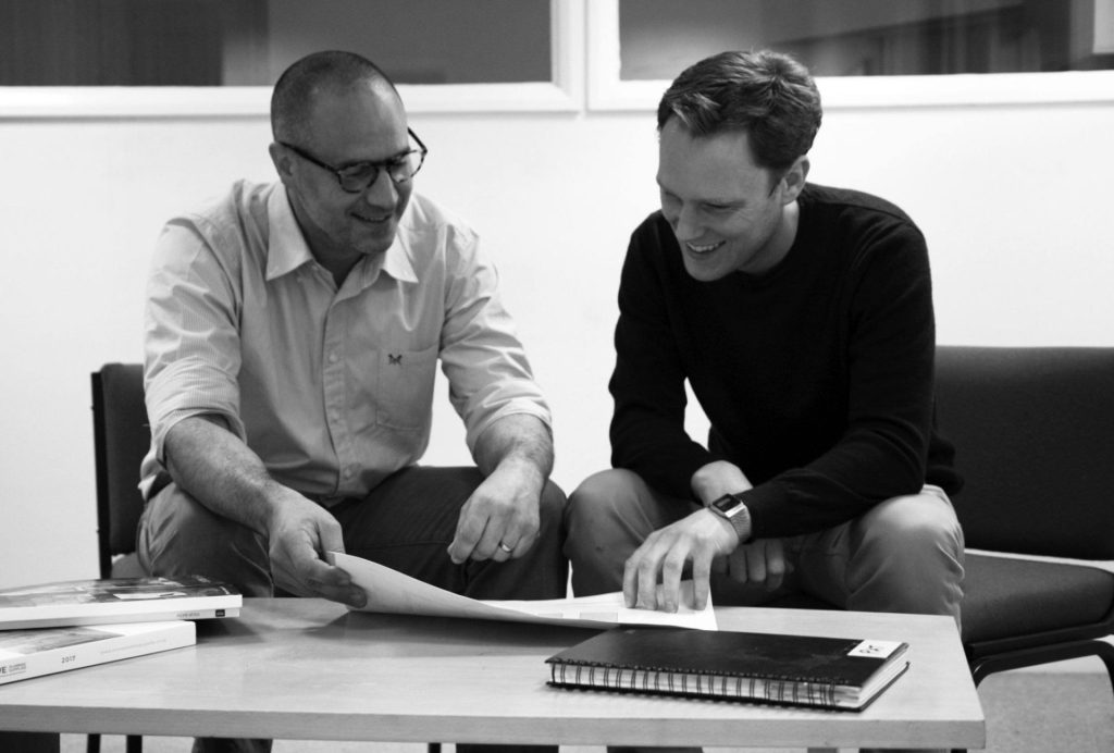 C. P. Jefferies team members looking at documents on a coffee table