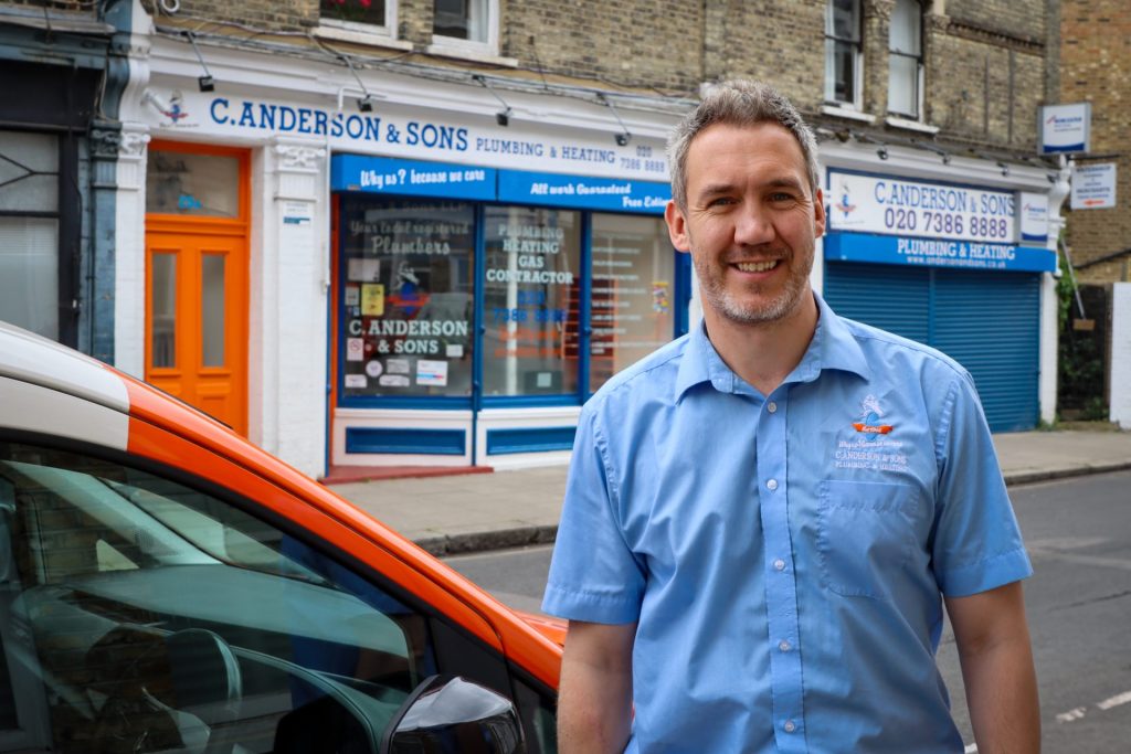 Crawford Anderson standing in front of C. Anderson & Sons premises