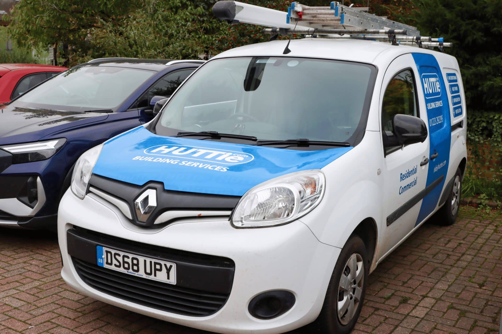 An image of a blue and white van belonging to Huttie Building Services, a Commusoft customer
