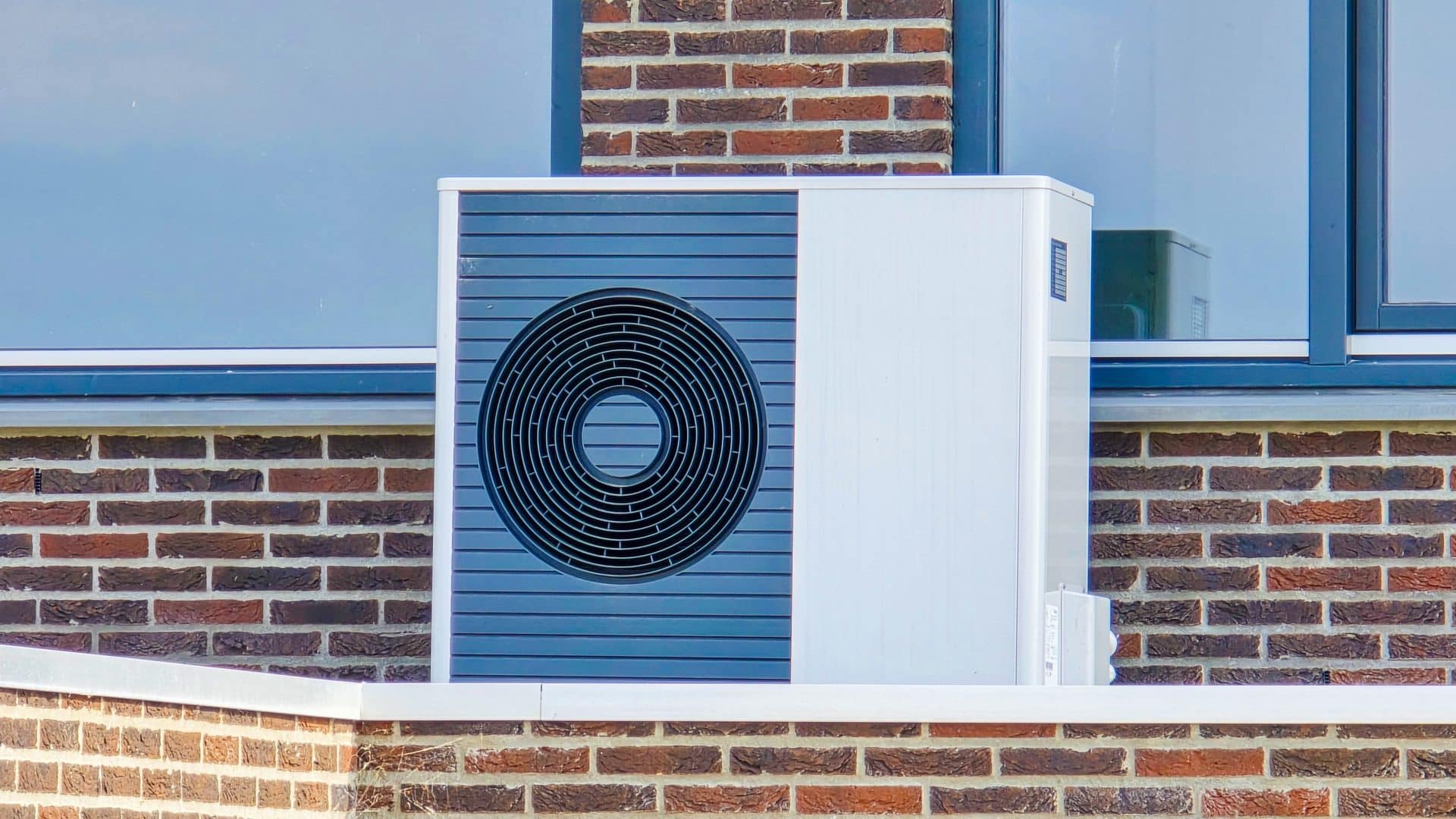 Air source heat pump installed outside a house