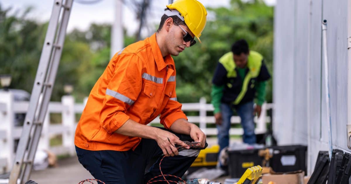 Electricians working outside with equipment