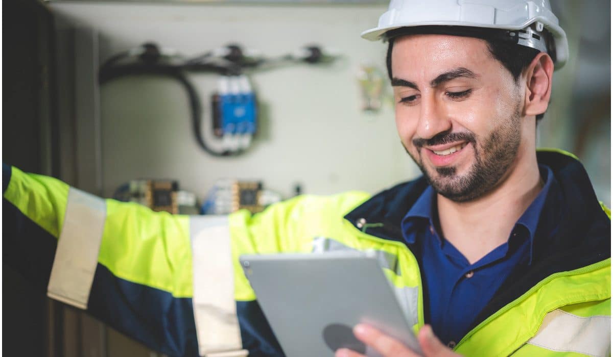 Engineer in high-vis jacket holding a tablet